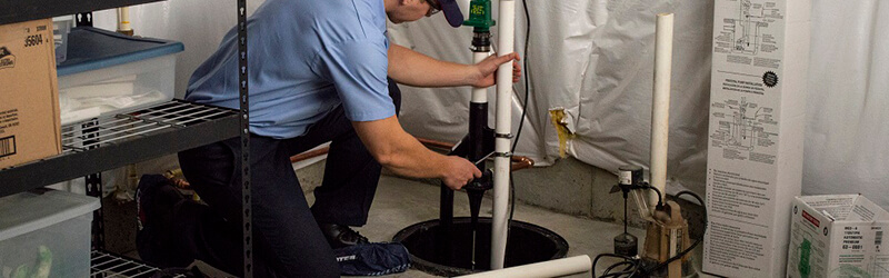 Roto-Rooter tech working on a sump pump